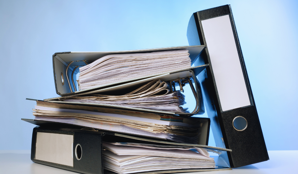 A stack of binders representing Bureaucracy