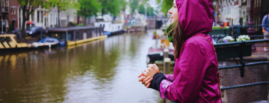 a woman standing in the rain in Amsterdam