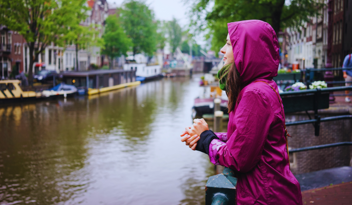 a woman standing in the rain in Amsterdam