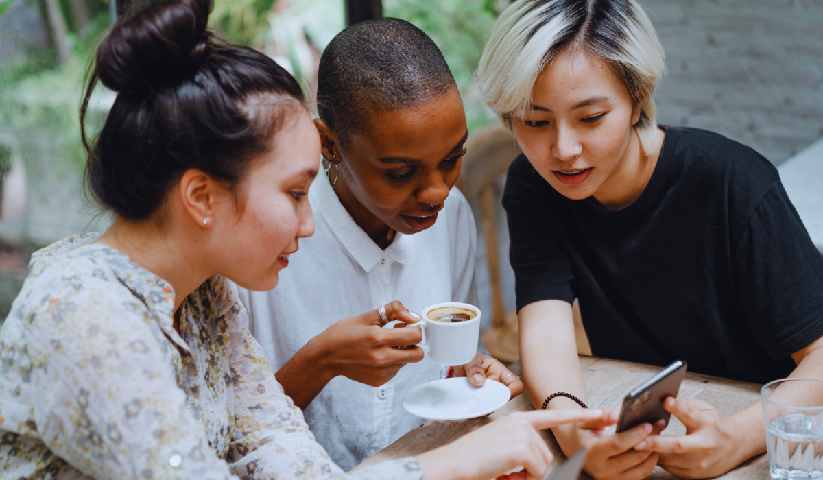three women checking social media forums