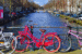 Three bikes against a canal on a sunny day in the netherlands