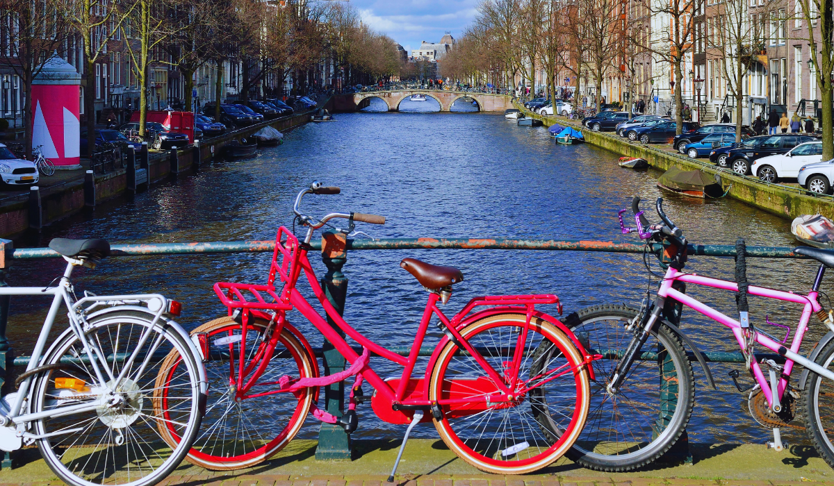 Three bikes against a canal on a sunny day in the netherlands