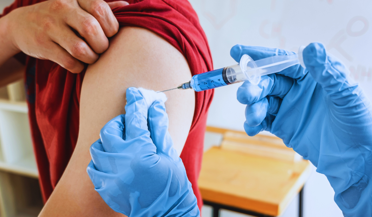 Doctors Injecting Vaccine Into Patients Arm