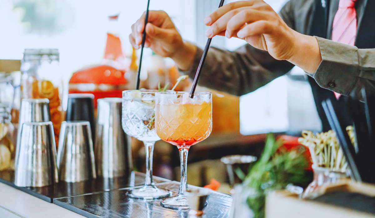 A Bartender mixing two cocktails
