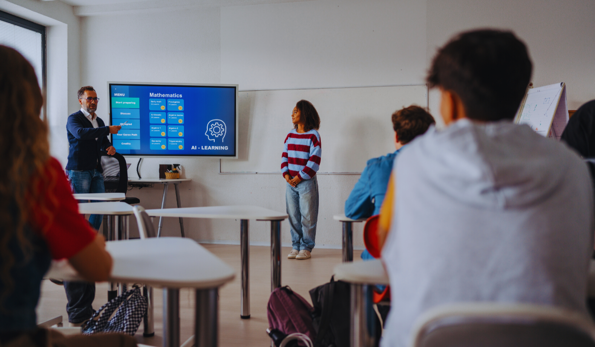 Teenage girl presenting an AI Learning project in the classroom