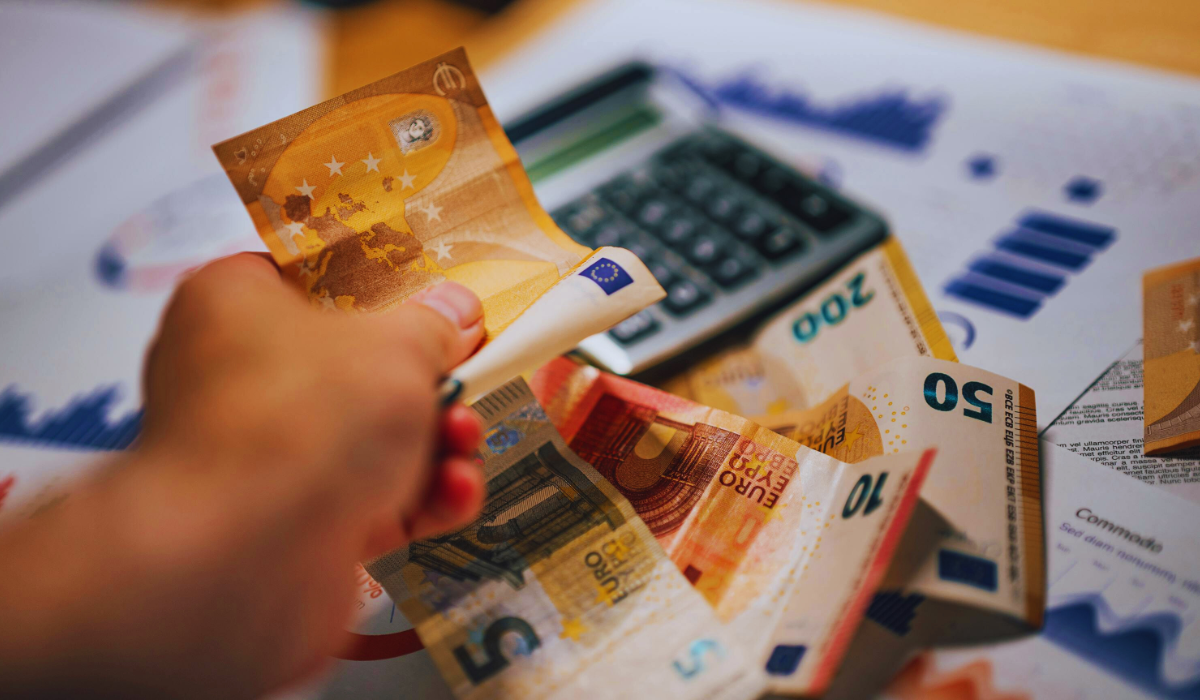 euro banknotes with financial documents and culculator