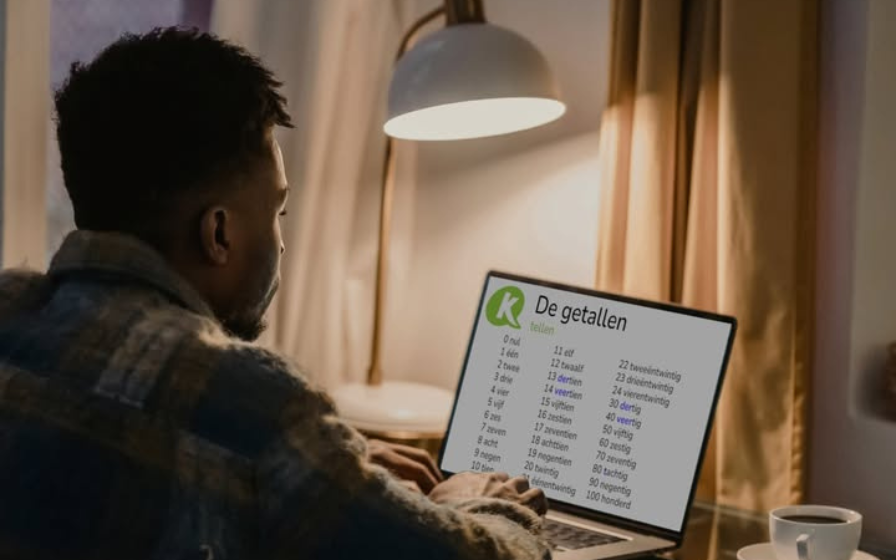 a man studying Dutch language with the Koetntact website