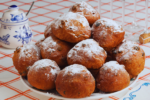 A plat of Oliebollen with powdered sugar