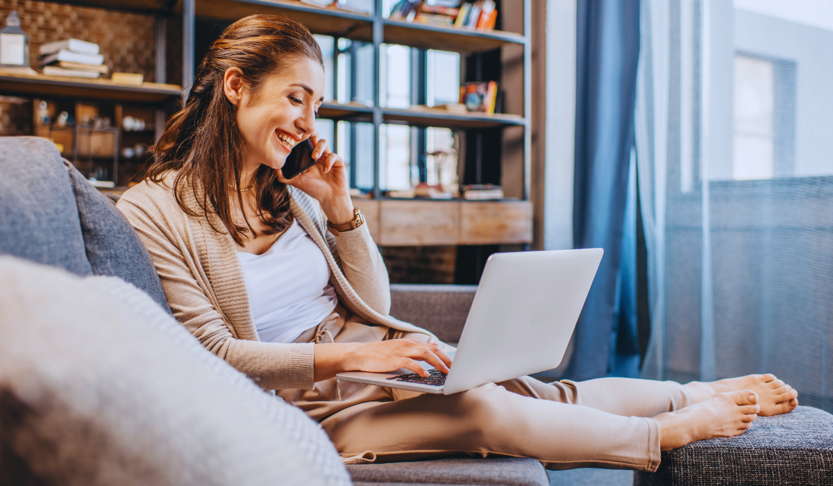 A business woman in the Netherlands doing remote work on her sofa