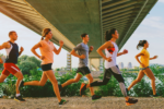 Members of a running club in the Netherlands running under a bridge