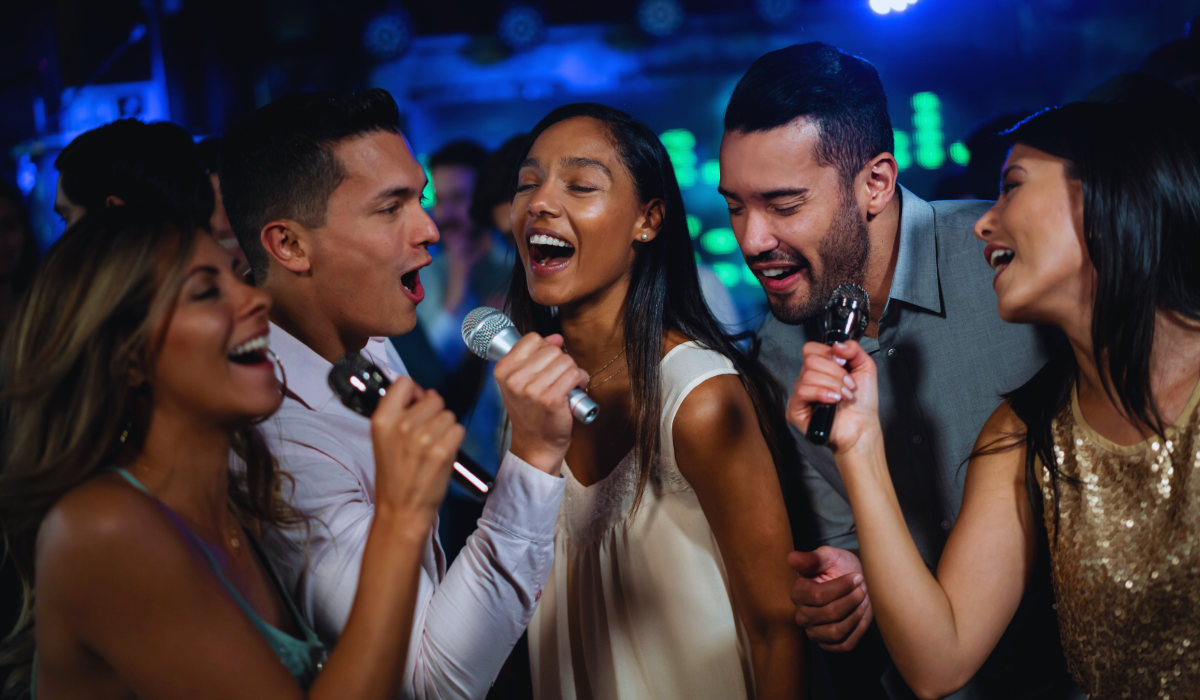A group of friends singing at one of the best karaoke bars in the netherlands