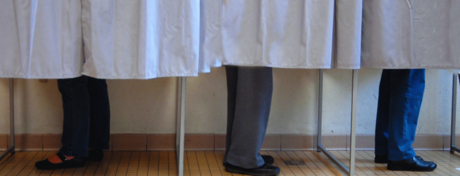Three voters in the booths for Amsterdam municipal elections 2026