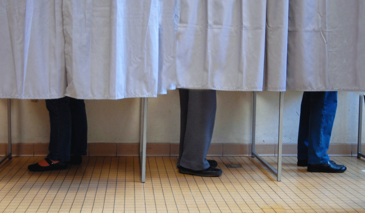 Three voters in the booths for Amsterdam municipal elections 2026