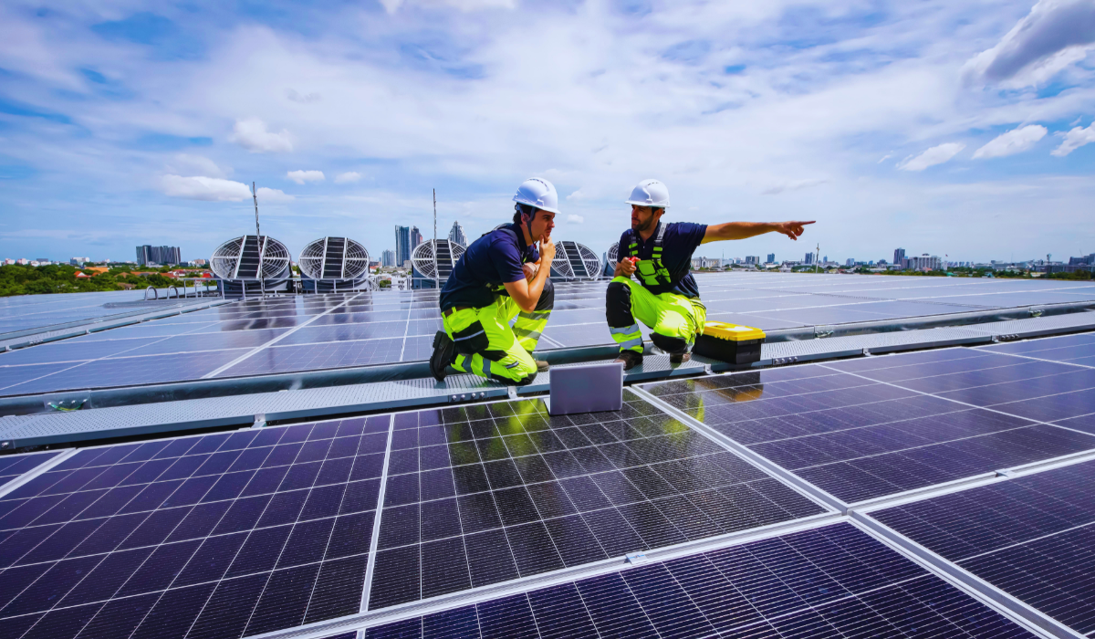 Two workers installing solar panels