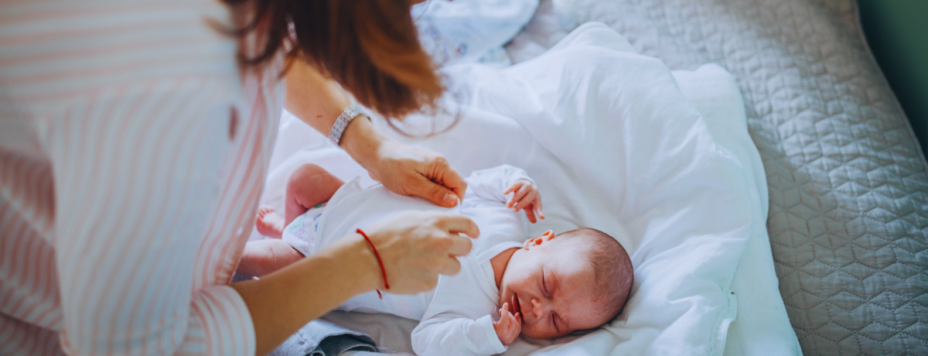 A mother changes her baby