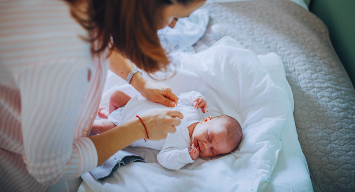 A mother changes her baby