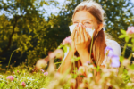 a young girl sneexing with hay fever in the netherlands