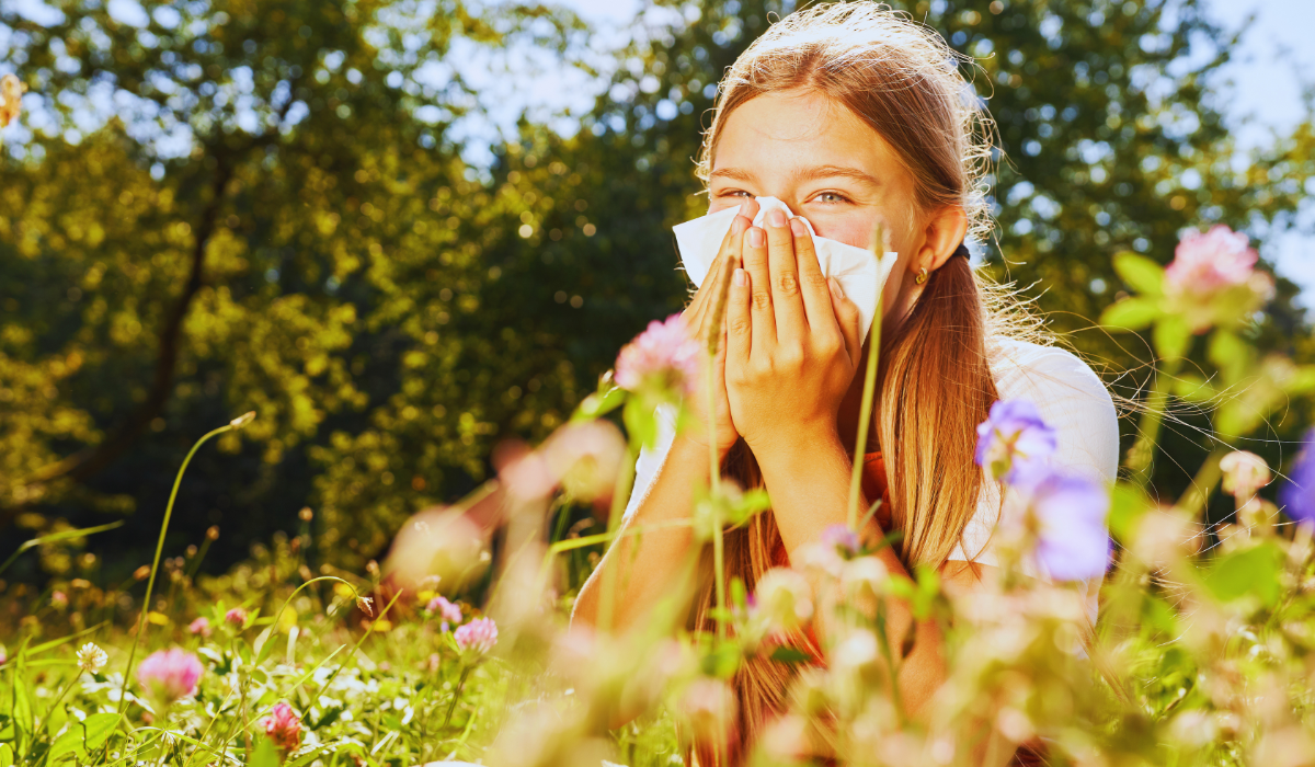 a young girl sneexing with hay fever in the netherlands