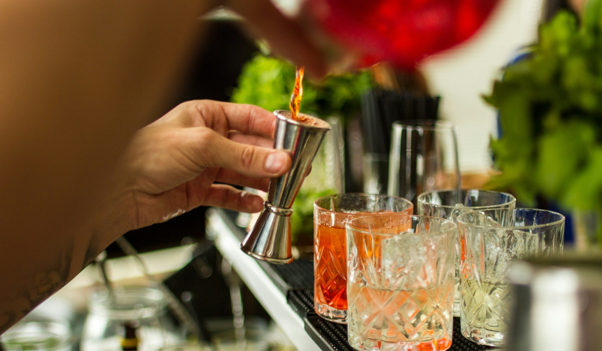 closeup of a bartender mixing an alcoholic cocktail at a fancy bar