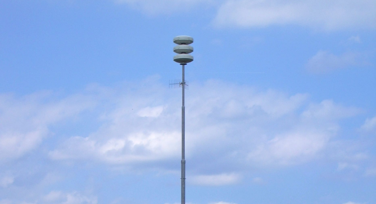 A tall NL-Alert air raid siren tower in the Netherlands