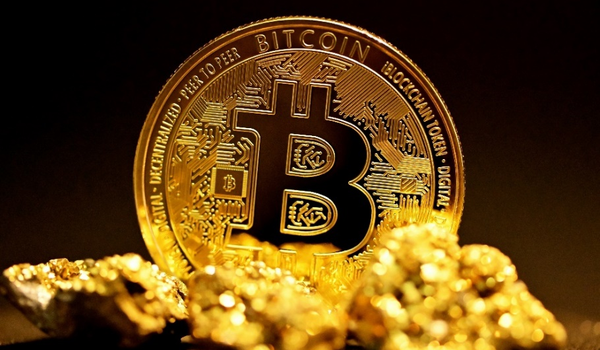 A gold bitcoin set against a black background