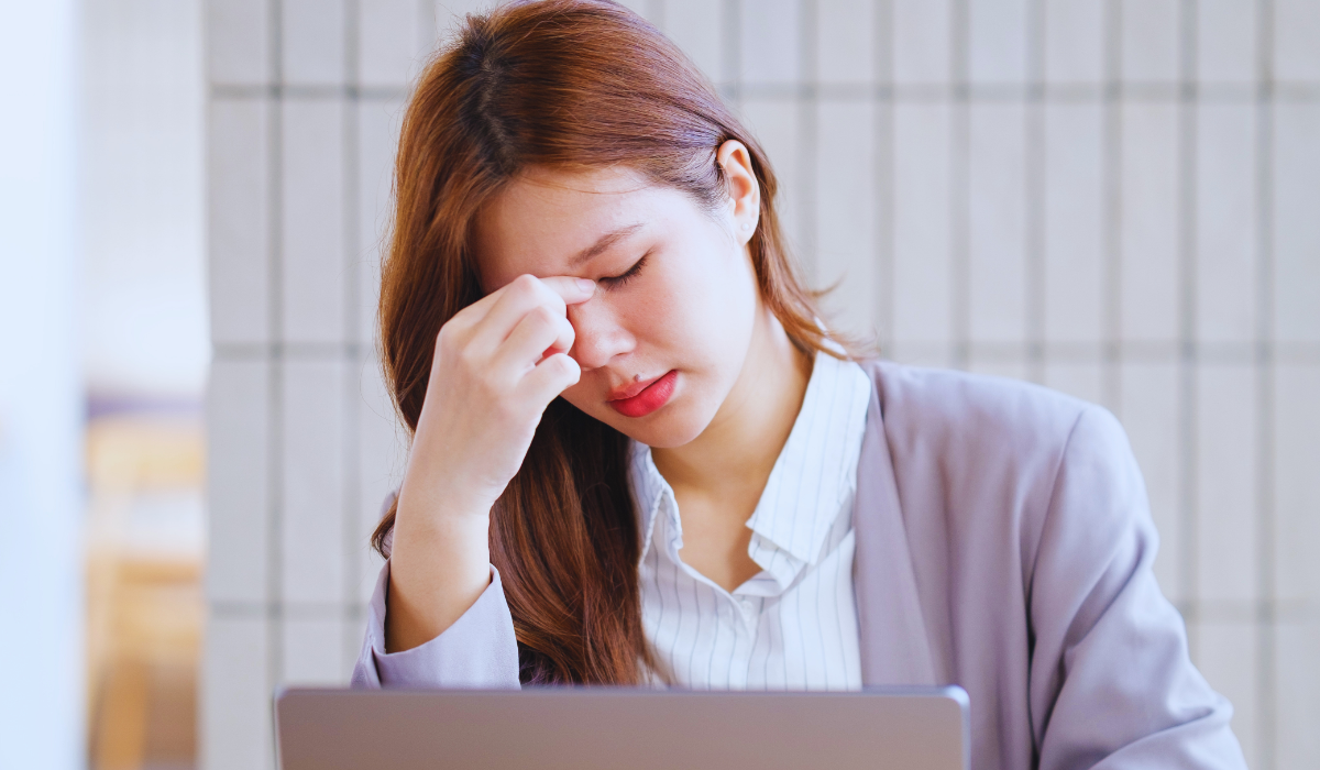 A young asian woman stressed out wheile working