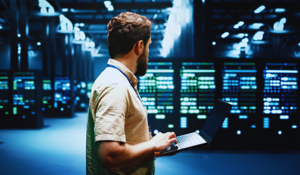 Man Inspecting servers inside a data center