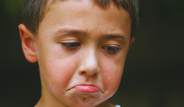 A sad boy puting