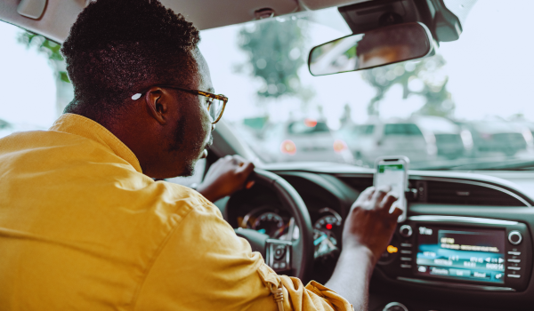 Uber driver checks his smartphone