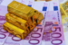 gold bars set against euro notes