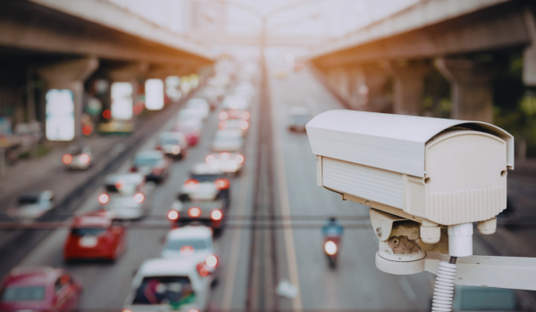 Surveillance camera watching busy highway traffic