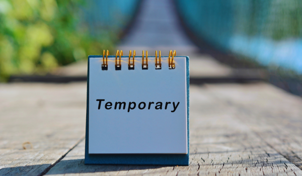 a sign that reads temporary ona white piece of paper